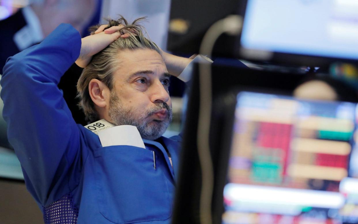 A trader on the floor at the New York Stock Exchange - ANDREW KELLY/REUTERS