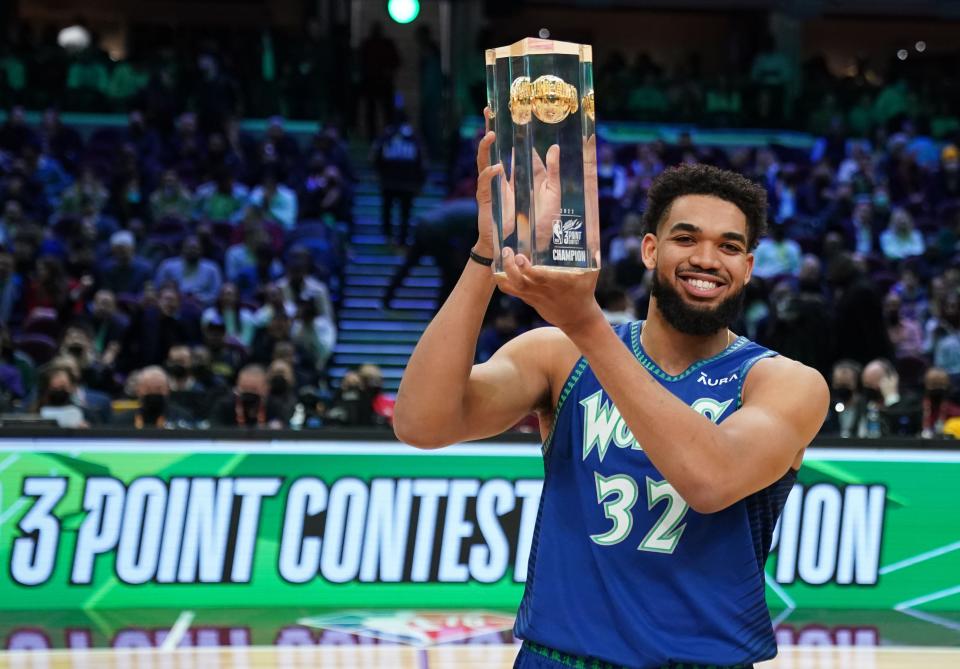 Karl-Anthony Towns (32) holds the trophy after winning the Skills Challenge during the 2022 NBA All-Star Saturday Night at Rocket Mortgage Field House.