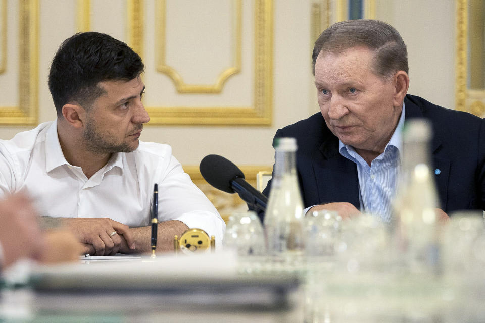 FILE In this file photo taken on Monday, June 3, 2019 provided by the Ukrainian Presidential Press Office, Ukrainian president Volodymyr Zelenskiy, left, listens to former Ukrainian president Leonid Kuchma, a special Ukrainian presidential envoy in the contact group for talks on a cease-fire in Eastern Ukraine, during their meeting in Kiev, Ukraine. Ukraine's president sits down Monday, Dec. 9, 2019 for peace talks in Paris with Russian President Vladimir Putin in their first face-to-face meeting, and the stakes could not be higher. More than five years of fighting in eastern Ukraine between government troops and Moscow-backed separatists has killed more than 14,000 people, and a cease-fire has remained elusive. (Ukrainian Presidential Press Office via AP, File)