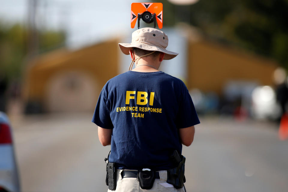 An FBI agent investigates the site of the shooting at the First Baptist Church of Sutherland Springs, Texas. (Photo: Jonathan Bachman/Reuters)