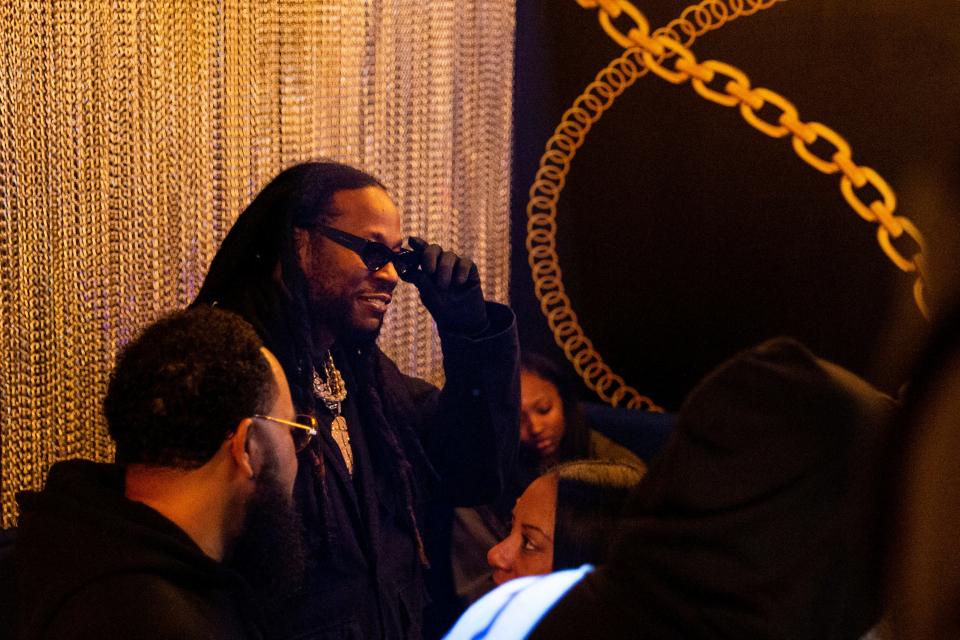Rapper 2 Chainz smiles as he stands in his reserved area decorated with golden chains during the opening celebration for Esco Restaurant and Tapas in Downtown Memphis, on Saturday, December 16, 2023.