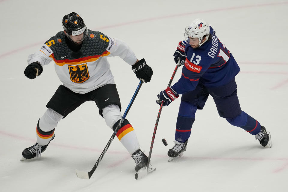 Germany's Tobias Fohrler, left, challenges for a puck with Unted States' Johnny Gaudreau during the preliminary round match between United States and Germany at the Ice Hockey World Championships in Ostrava, Czech Republic, Saturday, May 11, 2024. (AP Photo/Darko Vojinovic)