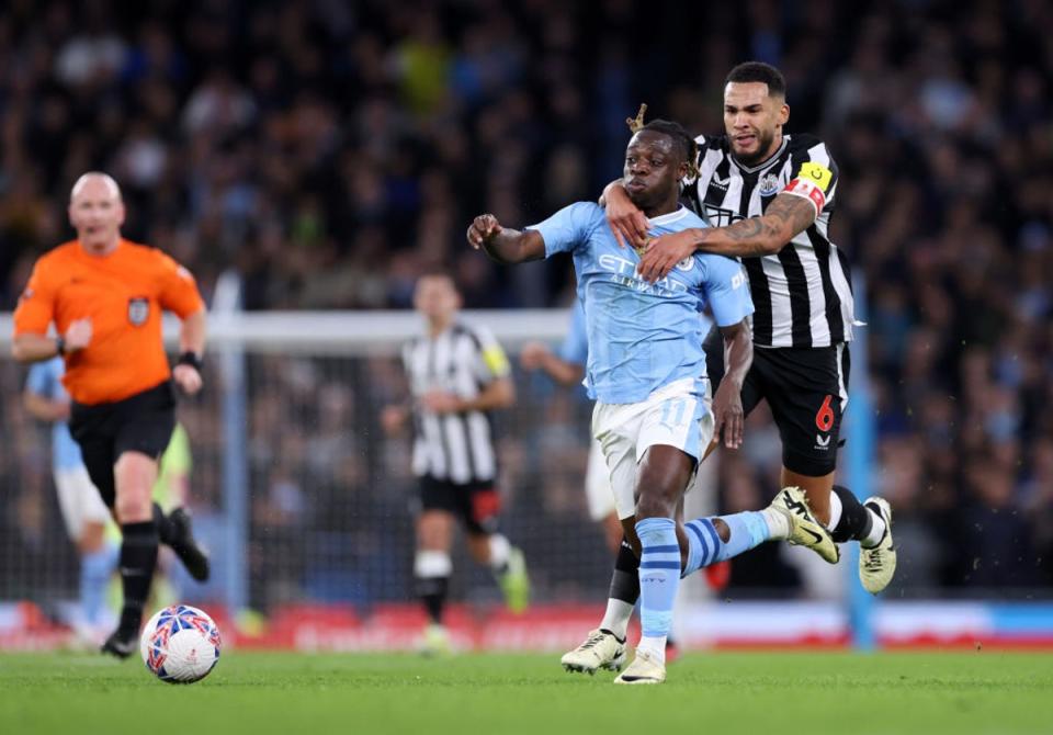Jeremy Doku of Manchester City is challenged by Jamaal Lascelles (Getty)