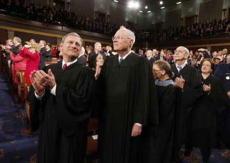 U.S. Supreme Court Chief Justice John Roberts (L) applauds with fellow Justices Anthony Kennedy (2nd L), Ruth Bader Ginsburg, Stephen Breyer and Elena Kagan (R) prior to President Barack Obama's State of the Union speech on Capitol Hill in Washington in this January 28, 2014 file photo. REUTERS/Larry Downing/Files
