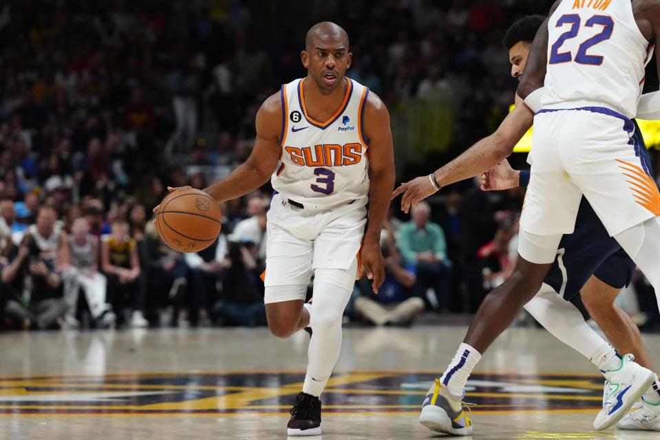 Phoenix Suns guard Chris Paul (3) dribbles the ball during the first quarter against the Denver Nuggets in Game 2 of the NBA playoff series at Ball Arena.