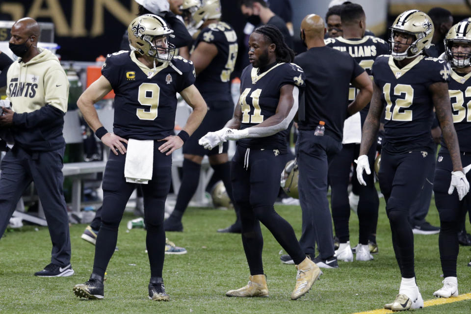 New Orleans Saints quarterback Drew Brees (9) walks on the sideline with running back Alvin Kamara (41) in the second half of an NFL football game against the San Francisco 49ers in New Orleans, Sunday, Nov. 15, 2020. Brees was replaced by quarterback Jameis Winston. (AP Photo/Butch Dill)