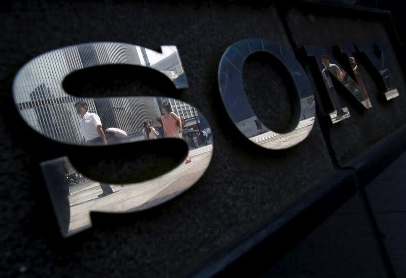 Pedestrians are reflected in a logo of Sony Corp outside its showroom in Tokyo, Japan, June 23, 2015. REUTERS/Yuya Shino