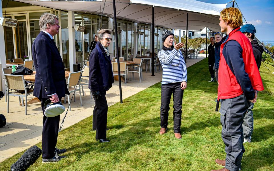 The Princess Royal talks with instructors and students during a visit to the Royal Yacht Squadron at The Castle in Cowes, Isle of Wight - PA