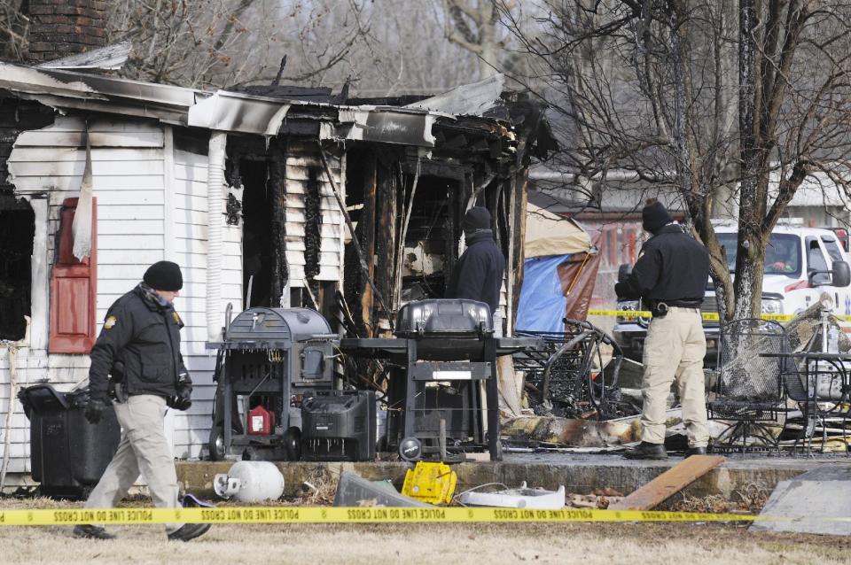 Kentucky State Police fire investigators at the scene of an early morning blaze Thursday Jan. 30, 2014, at a home in Greenville, Ky., where nine people are presumed dead. Remains of six people were found and three people are missing. (AP Photo/The Gleaner, Mike Lawrence)