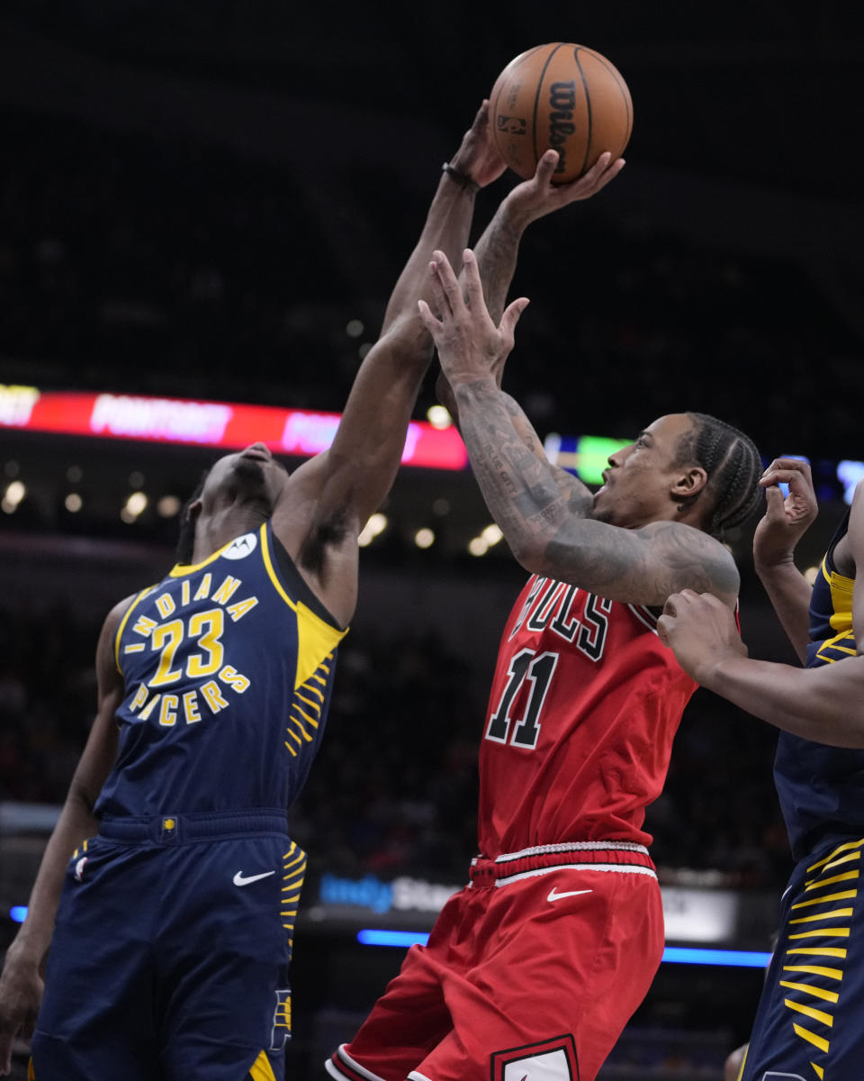 Indiana Pacers forward Aaron Nesmith (23) blocks the shot of Chicago Bulls forward DeMar DeRozan (11) during the second half of an NBA basketball game in Indianapolis, Tuesday, Jan. 24, 2023. The Pacers defeated the Bulls 116-110. (AP Photo/Michael Conroy)