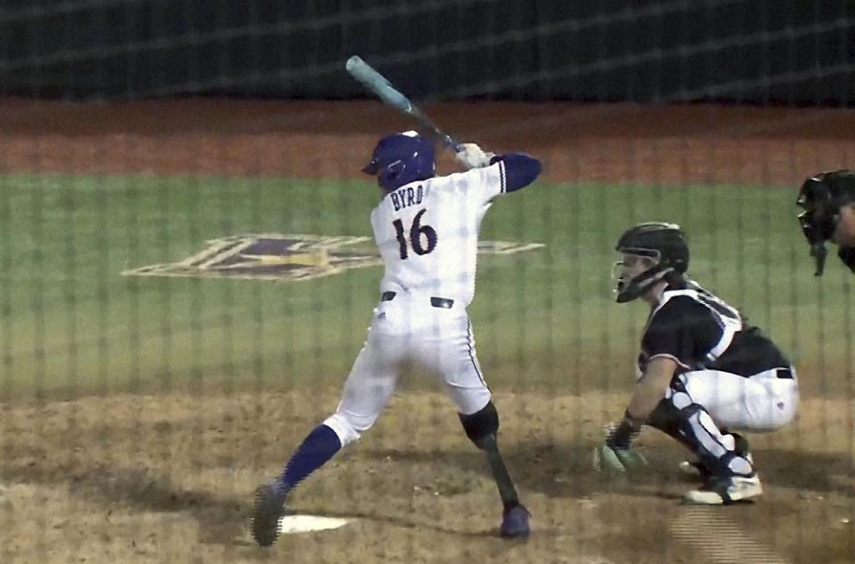 This image from video provided by WITN-TV shows Parker Byrd (16) during an NCAA college baseball game, Friday, Feb. 16, 2024 in Greenville, N.C. East Carolina sophomore Parker Byrd appeared in Friday’s season-opening win against Rider with a prosthetic leg after having part of his right leg amputated following a 2022 boating accident. The school said he is the first NCAA Division I athlete to play in a game with a prosthetic leg. (WITN via AP)