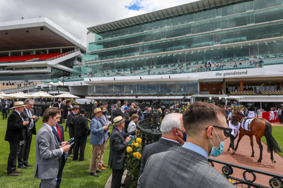 Spectators gathered around the Mounting yard ahead of Race 1 at Derby Day at Flemington Racecourse on October 30, 2021.