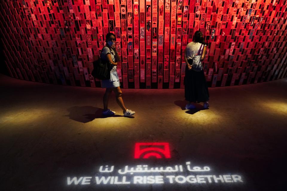 Women walk through Syria's pavilion at Expo 2020 in Dubai, United Arab Emirates, Saturday, Oct. 2, 2021. Dubai has gambled billions to make the gleaming, built-from-scratch Expo village a triumphant tourist attraction and symbol of the United Arab Emirates itself — a feast for the eyes devoid of politics and built on the promise of globalization. But even as nations use their pavilions for benign infomercials, the political turbulence of the wider world somehow manages to intrude. (AP Photo/Jon Gambrell)