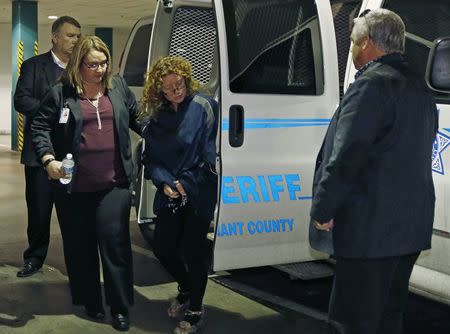Tonya Couch (C) is escorted by a sheriff's deputy as she arrives at the Tarrant County Jail in Fort Worth, Texas, January 7, 2016. REUTERS/Paul Moseley/Ft. Worth Star-Telegram