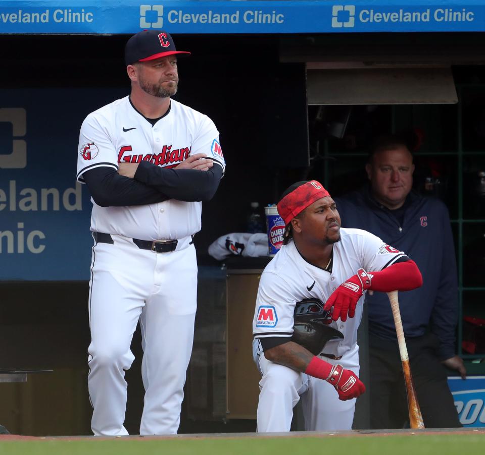 Guardians manager Stephen Vogt, left, and third baseman Jose Ramirez watch from the dugout during the third inning of the home opener against the Chicago White Sox, Monday, April 8, 2024.