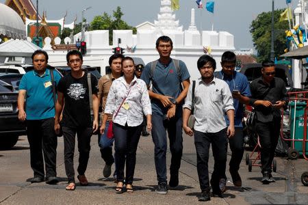 Eight people charged with ridiculing junta leader Prayuth Chan-ocha arrive at the military court in Bangkok, Thailand, August 23, 2016. REUTERS/Chaiwat Subprasom