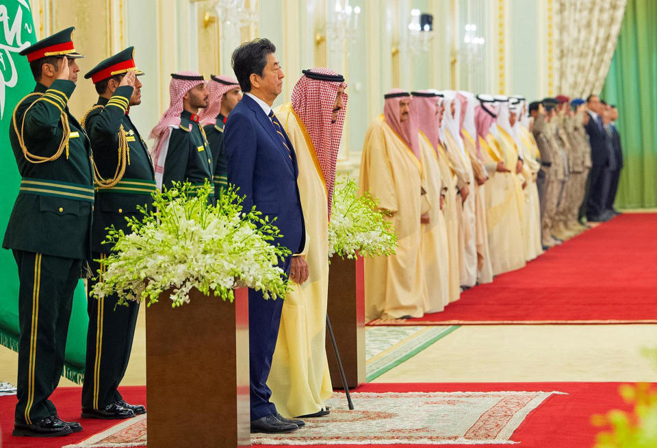 In this photo released by Saudi Press Agency, SPA, Saudi King Salman, center left, stands with Japan's Prime Minister Shinzo Abe in Riyadh, Saudi Arabia, Sunday, Jan. 12, 2020. (Saudi Press Agency via AP)