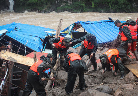 Paramilitary policemen search for missing people at the site of a landslide in Sanming, Fujian province, China, May 8, 2016. China Daily/via REUTERS A