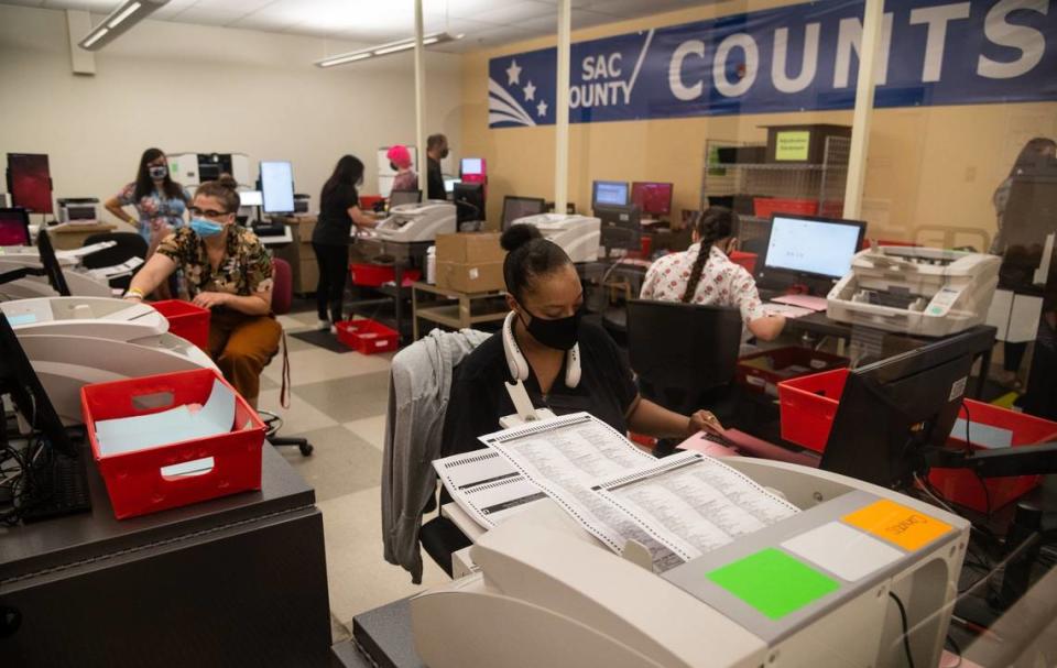 Election workers count ballots in the tabulation room at the Sacramento County Registrar of Voters office in south Sacramento in September 2021.