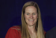 FILE - United States Soccer Federation president Cindy Parlow Cone smiles during induction ceremonies at the National Soccer Hall of Fame in Frisco, Texas, Saturday, Oct. 2, 2021. U.S. women soccer players reached a landmark agreement with the sport's American governing body to end a six-year legal battle over equal pay, a deal in which they are promised $24 million plus bonuses that match those of the men. The U.S. Soccer Federation and the women announced a deal Tuesday, Feb. 22, 2022, that will have players split $22 million, about one-third of what they had sought in damages." (Jason Janik/The Dallas Morning News via AP, File)