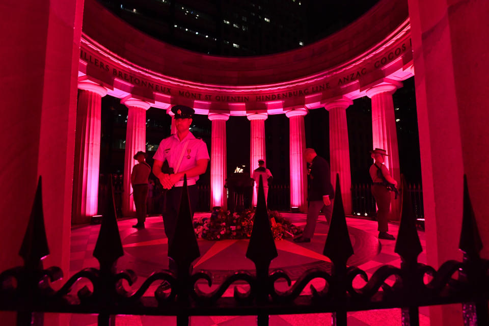 People are seen laying flowers at the Shrine of Remembrance during the Anzac Day dawn service in Anzac Square in Brisbane. Source: AAP