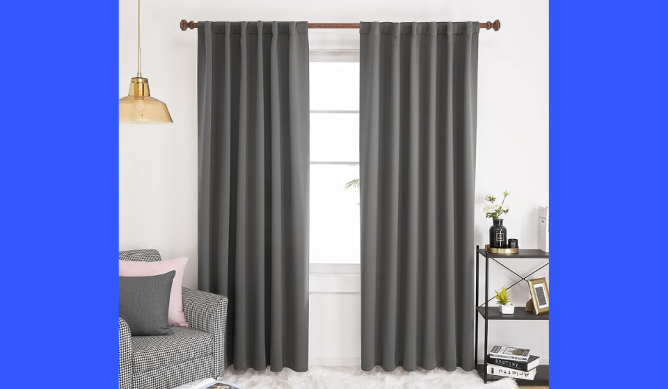 the blackout curtains in gray hanging on a window
