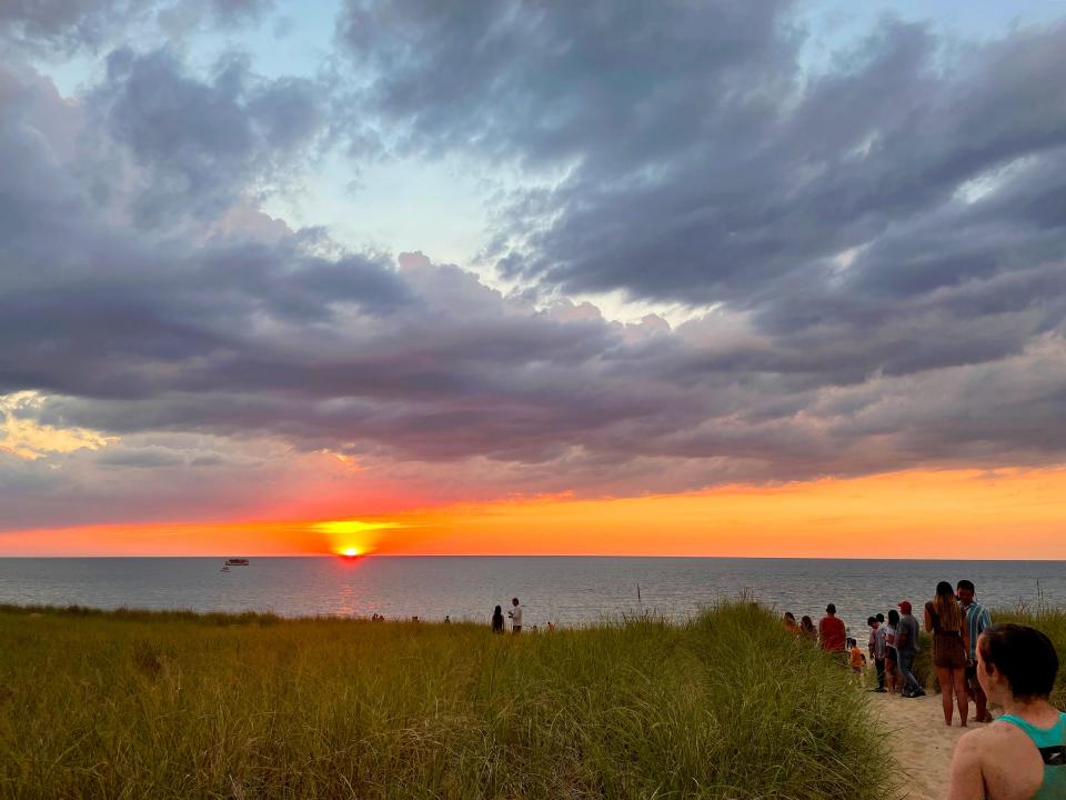 People walk down to the beach to watch the sunset over Lake Michigan in Michigan City, Indiana in June of 2021. - Mike De Sisti / Milwaukee Journal Sentinel