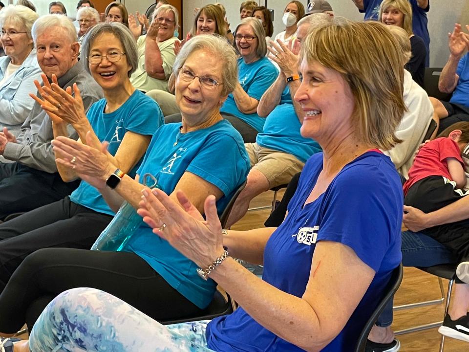 S.A.I.L. instructor Debbie Harris, right, receives applause from a room full of friends at her retirement party at Karns Senior Center Wednesday, May 4, 2022.