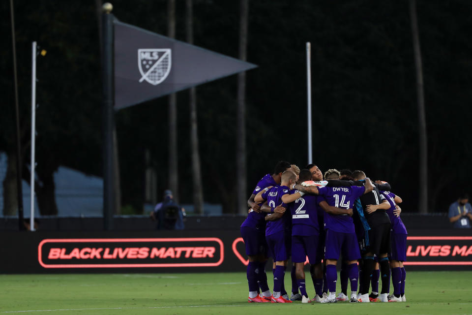 A group of MLS players huddles during an MLS is Back Tournament game.