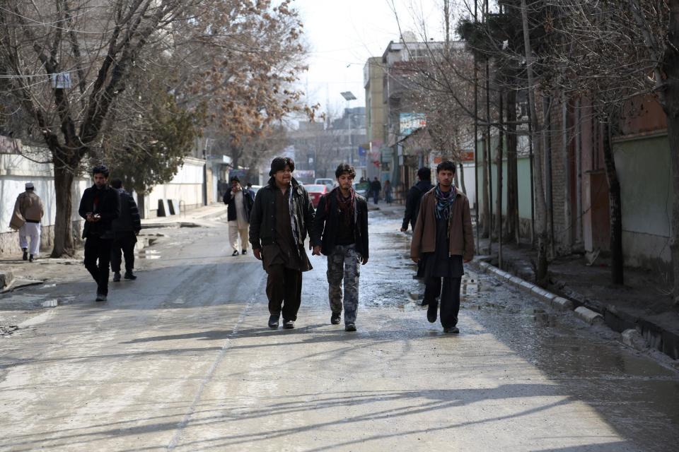 Afghan men walk at the scene where a Swedish journalist was shot to death while he was talking to a translator in Wazir Akbar Khan, Kabul, Afghanistan on Tuesday, March 11, 2014. Nils Horner, 51, who also had British citizenship, had worked for Swedish Radio SR since 2001 as a foreign correspondent mostly in Asia and the Middle East, including Afghanistan and Baghdad. (AP Photo/Rahmat Gul)