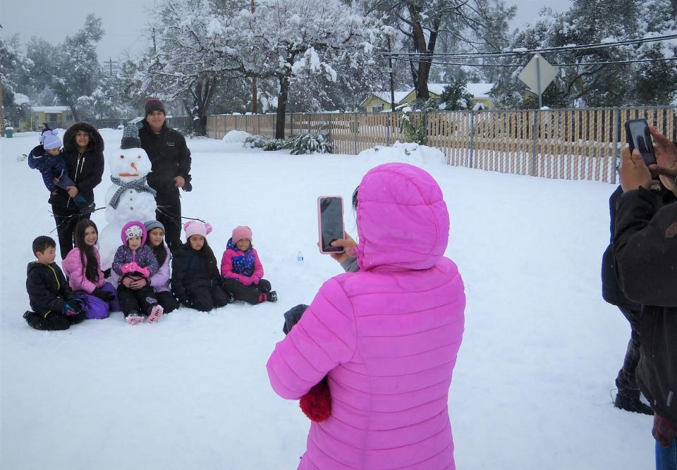 A snowman poses for photos with his Redding family Friday.