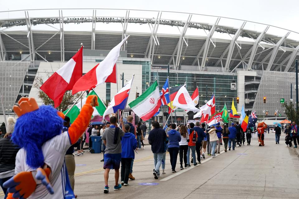 FIFA World Cup 2026 supporters cheer as a parade of flags is walked down Freedom Way as the 2026 Cincy Local Organizing Committee hosted a street festival ahead of a visit by a FIFA and US Soccer Delegation, Friday, Oct. 22, 2021, along Freedom Way between Walnut and Elm Streets in Downtown Cincinnati. The delegation visited Paul Brown Stadium, soccer training facilities and Fan Fest locations.