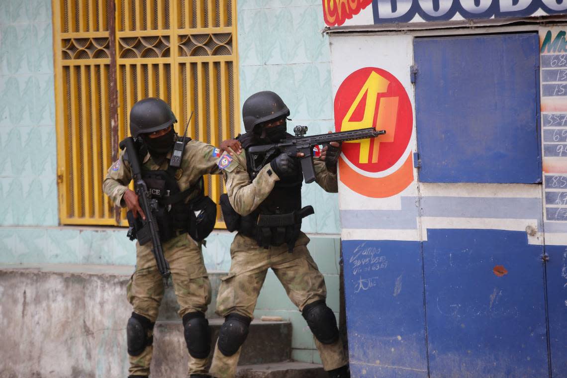Police take cover during an anti-gang operation at Portail neighborhood in Port-au-Prince, Haiti, Thursday, Feb. 29, 2024. Gunmen shot at the international airport and other targets in a wave of violence that forced businesses, government agencies and schools to close early. Odelyn Joseph/AP