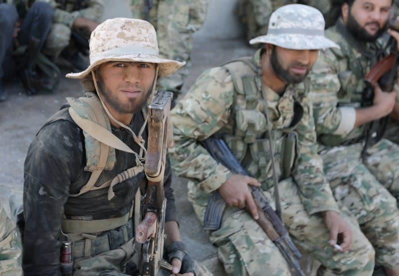 Turkey-backed Syrian rebel fighters gather near the border town of Tal Abyad