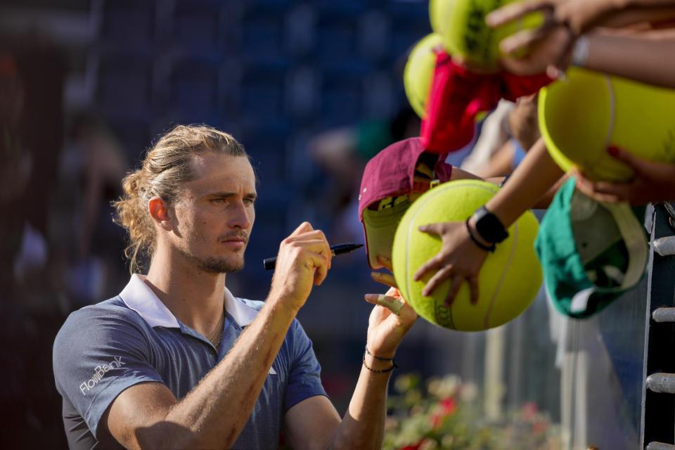 Germany's Alexander Zverev signs autographs after defeating Chile's Alejandro Tabilo in a men's tennis semifinal match at the Italian Open tennis tournament, in Rome, Friday, May 17, 2024. (AP Photo/Andrew Medichini)