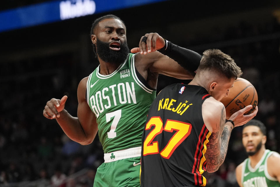 Atlanta Hawks guard Vit Krejci (27) is fouled by Boston Celtics guard Jaylen Brown (7) during the first half of an NBA basketball game Thursday, March 28, 2024, in Atlanta. (AP Photo/John Bazemore)