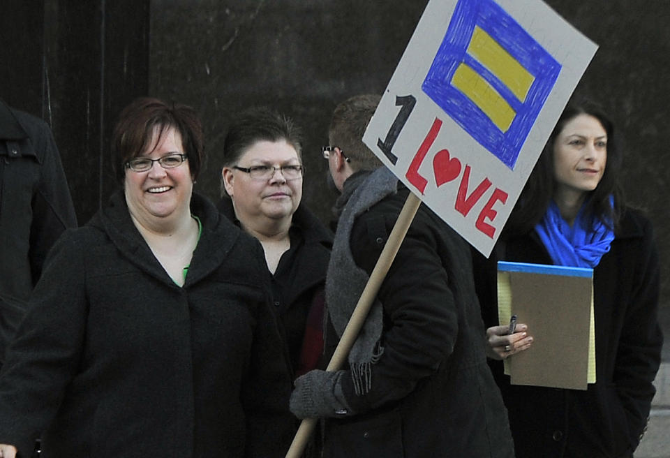 From left, April DeBoer and Jayne Rowse with DeBoer's attorney Dana Nessel enter Federal Court in Detroit, Tuesday, Feb. 25, 2014 before a trial that could overturn Michigan's ban on gay marriage. Gay couples poised for a favorable ruling last fall had lined up for licenses at county offices across Michigan, only to be stunned when U.S. District Judge Bernard Friedman said he wanted to hear testimony from experts. The case began in 2012 when nurses Rowse, 49, and DeBoer, 42, of Hazel Park sued to try to upset a Michigan law that bars them from adopting each other's children. But the case became even more significant when Friedman invited them to add the same-sex marriage ban to their lawsuit. They argue that Michigan's constitutional amendment, approved by voters in 2004, violates the U.S. Constitution's Equal Protection Clause, which forbids states from treating people differently under the law. (AP Photo/Detroit News, Daniel Mears) DETROIT FREE PRESS OUT; HUFFINGTON POST OUT