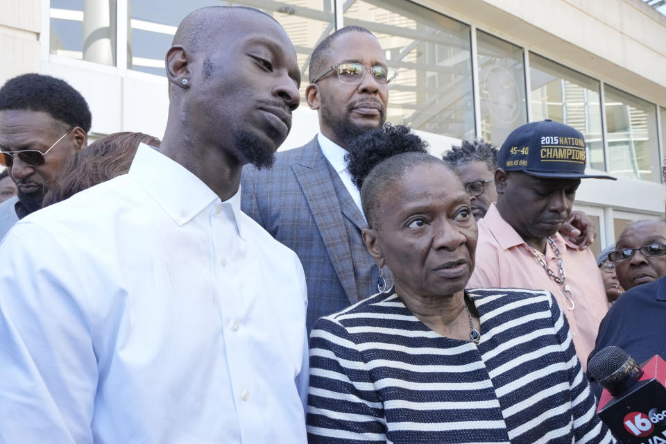 Michael Corey Jenkins, left, stands with his mother Mary Jenkins, center, and his friend Eddie Terrell Parker, right outside the Thad Cochran United States Courthouse in Jackson, Miss., Tuesday, March 19, 2024, following the 20-year sentence one of the six former Mississippi Rankin County law enforcement officers who committed numerous acts of racially motivated, violent torture on the two men in 2023, received. Sentencing continues Tuesday afternoon for the other five former law men in federal court. (AP Photo/Rogelio V. Solis)