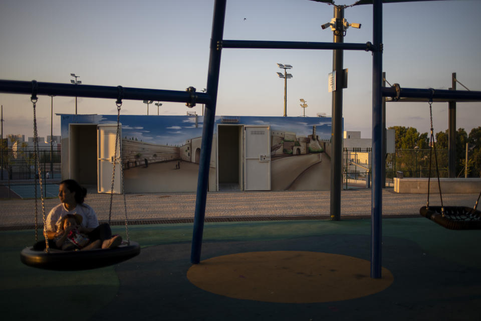 The doors of bomb shelters are open in a public park in Sderot, Israel, Wednesday, July 28, 2021. No place in Israel has been hit harder by Palestinian rocket fire than Sderot, a working-class town just about a mile (1.5 kilometers) from the Gaza border. Although Sderot is enjoying an economic boom and revival, a generation of children and parents are suffering from the traumatic effects of two decades of rocket fire that experts are still struggling to understand. (AP Photo/Ariel Schalit)