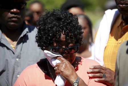 Judy Scott, mother of the late Walter Scott, wipes a tear as relatives and friends gathered to remember Scott, at Live Oak Memorial Gardens in Charleston, South Carolina, April 4, 2016. REUTERS/Randal Hill