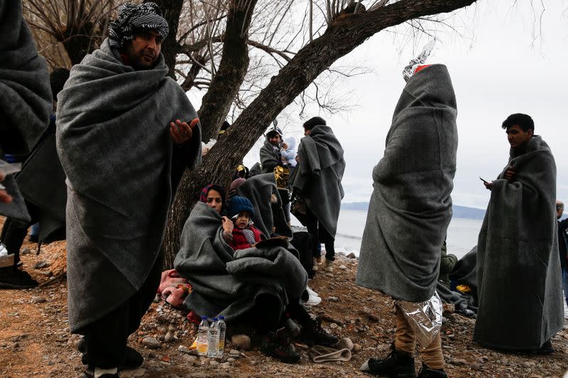 Migrants from Afghanistan are seen on a beach after arriving on a dinghy, near the village of Skala Sikamias on the island of Lesbos
