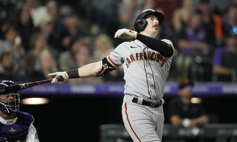 San Francisco Giants' Mike Yastrzemski follows the flight of his solo home run off Colorado Rockies relief pitcher Daniel Bard in the ninth inning of a baseball game Monday, May 16, 2022, in Denver. (AP Photo/David Zalubowski)