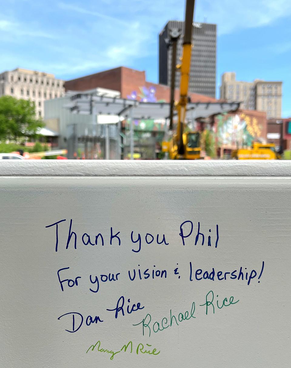 The final beam of the Maynard Performance Pavilion bears signatures from Dan Rice and family during a Lock 3 "topping off" ceremony.