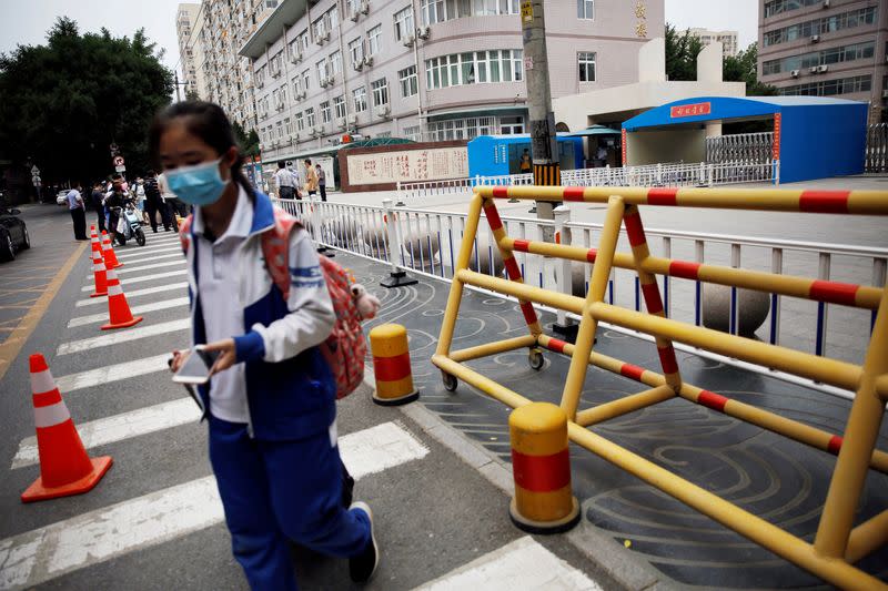 Student is seen outside a school after schools were shut to curb the new outbreak of the coronavirus disease (COVID-19) in Beijing