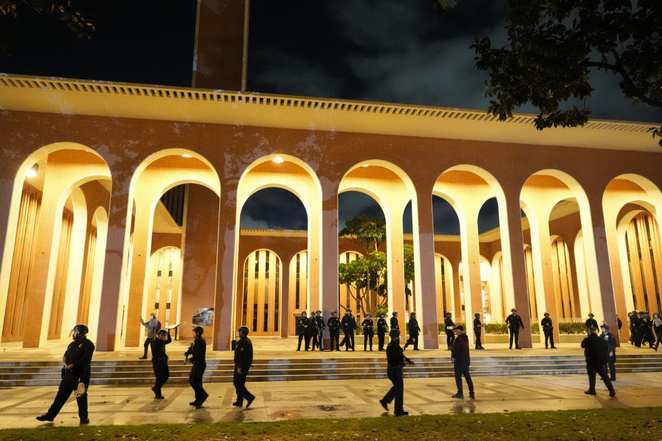 Police gather on the campus at the University of Southern California prior to clearing out an encampment set up by pro-Palestinian demonstrators Sunday, May 5, 2024, in Los Angeles. (AP Photo/Ryan Sun)