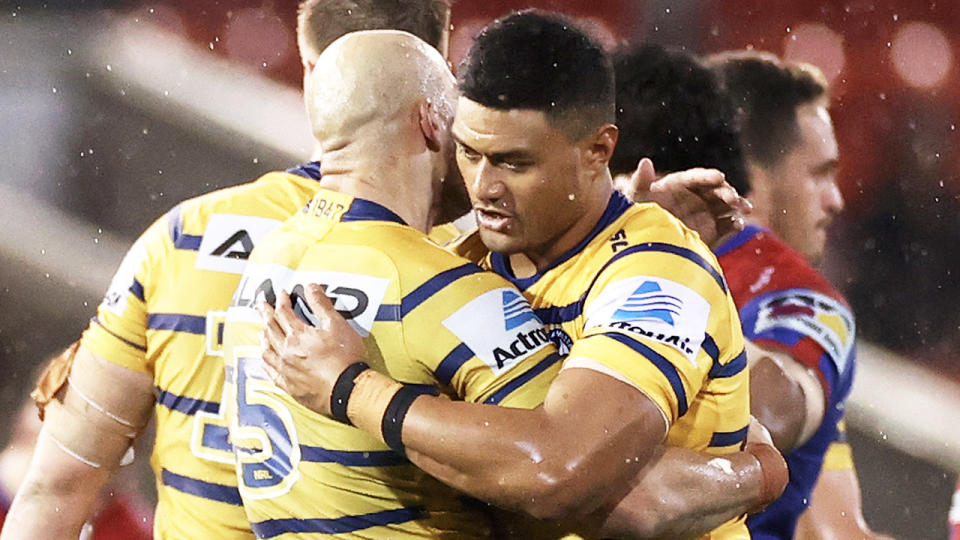 Stefano Utoikamanu (pictured right hugging teammate Blake Ferguson) will be sidelines after breaching the NRL's biosecurity measures when he embraced family and well-wishers after the game. (Getty Images)