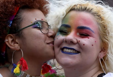 Participants pose for the picture at the canals during the annual gay pride parade in Amsterdam