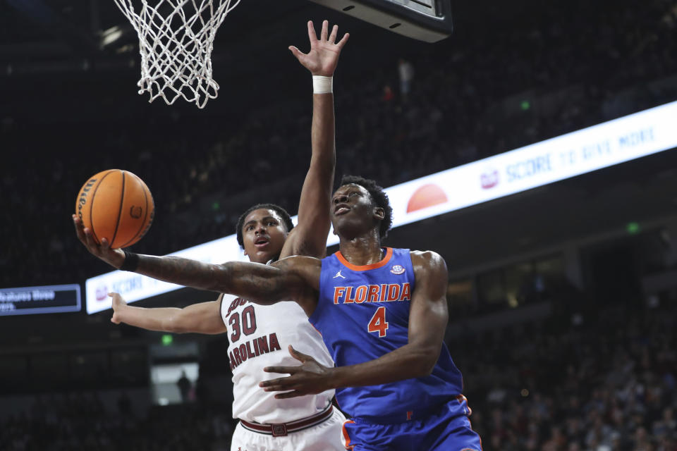 Florida forward Tyrese Samuel (4) attempts a reverse layup past South Carolina forward Collin Murray-Boyles (30) during the first half of an NCAA college basketball game Saturday, March 2, 2024, in Columbia, S.C. (AP Photo/Artie Walker Jr.)