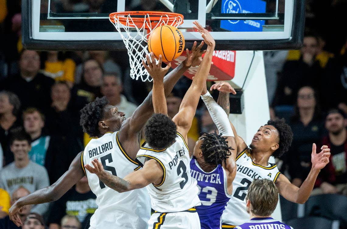 Wichita State’s Quincy Ballard, left, Craig Porter, middle and Jalen Ricks fight for a rebound against Central Arkansas’ Camren Hunter during the first half of their season-opening game on Monday night.