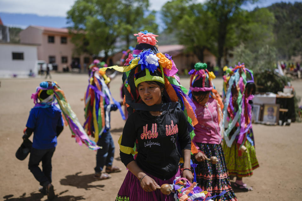 Raramuri Indigenous youth dance during a sacred Yumari ceremony to ask for rain and good crops and to honor two local Jesuit priests, Javier Campos and Joaquin Mora, who were murdered in 2022 by a gang leader, in Cuiteco, Mexico, Saturday, May 11, 2024. Among the inhabitants of the Tarahumara mountains, especially among the Indigenous Raramuri people, priests are often regarded as profoundly beloved figures who fearlessly offer comfort and help. (AP Photo/Eduardo Verdugo)